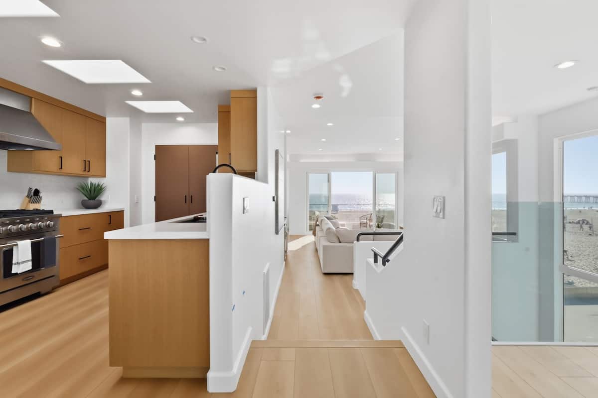 Kitchen and stair landing beneath natural light
