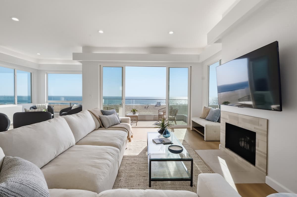 Oceanfront living room opening to a panoramic Pacific view