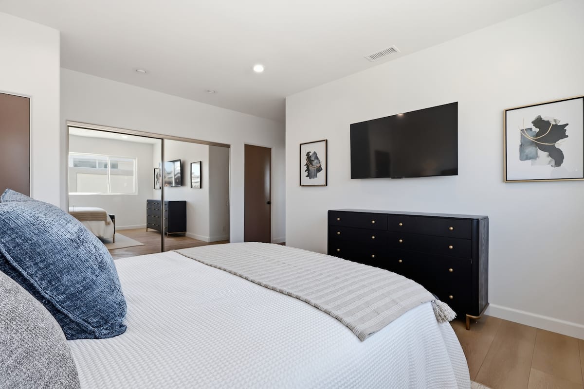 Third guest suite with upholstered bed and layered linens