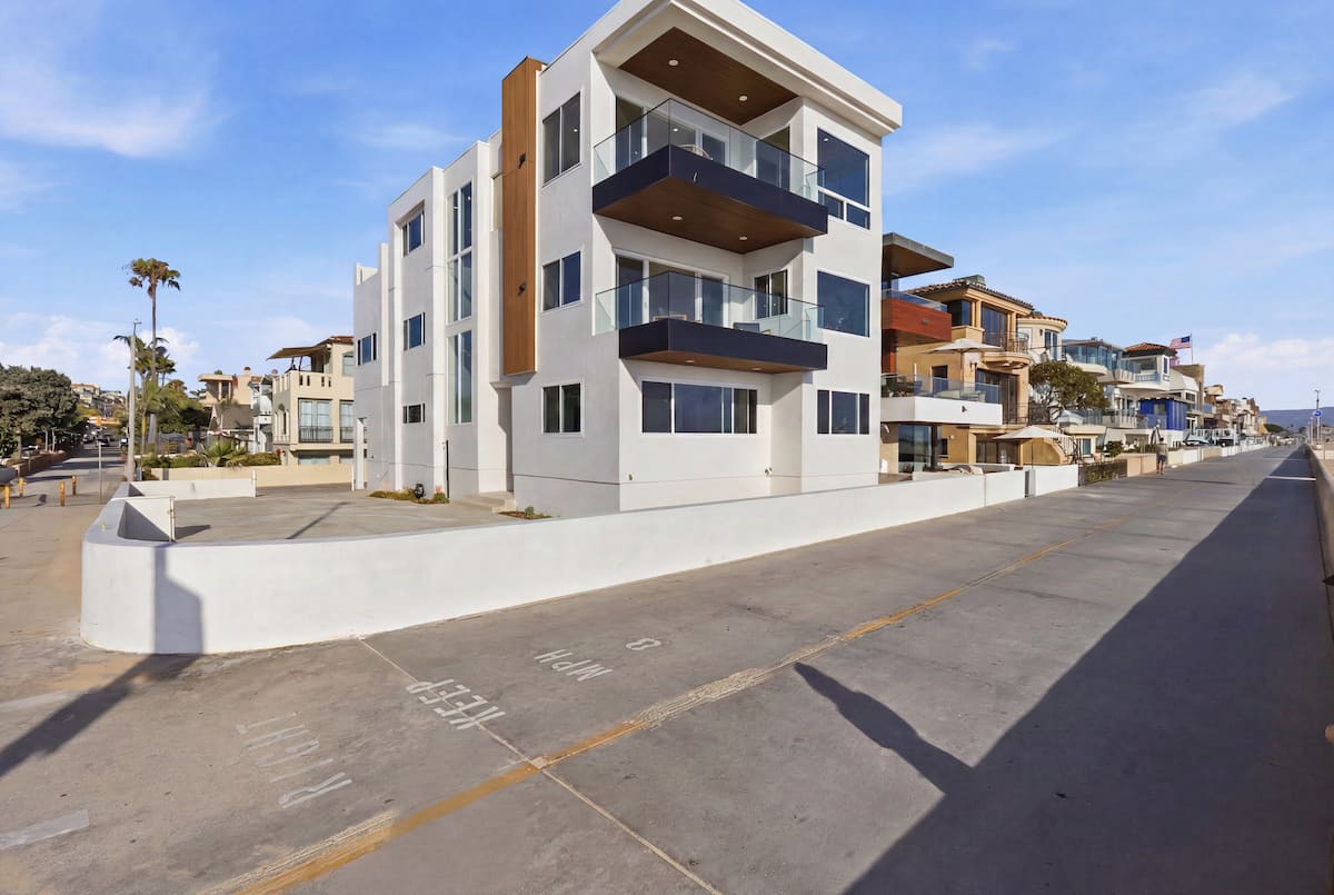 Modern white exterior of 740 The Strand beside the beach